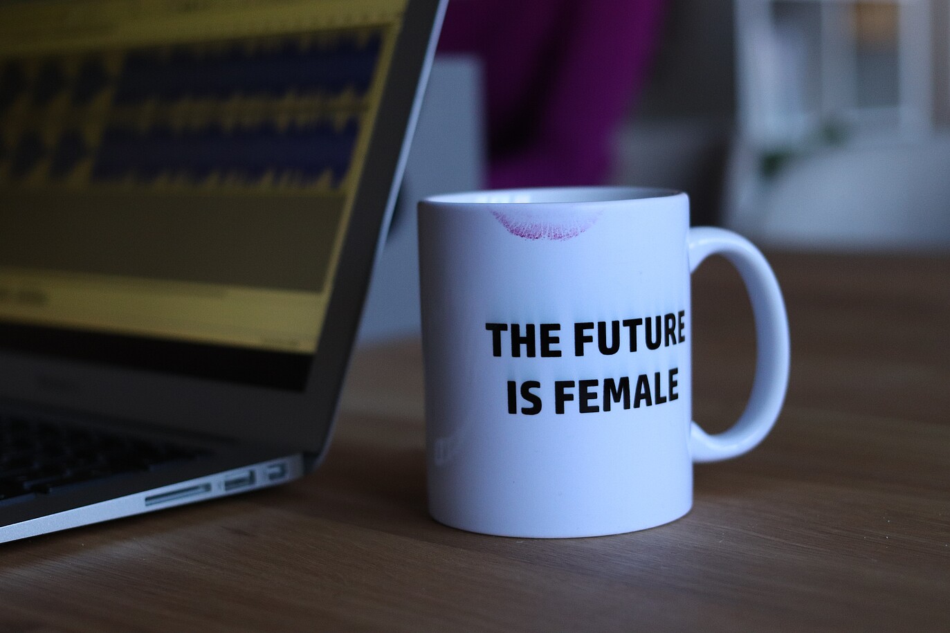 Laptop with mug that says "The Future is Female"
