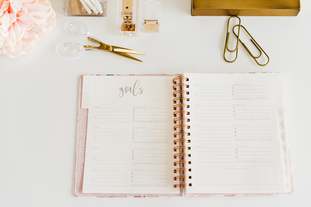 Open notebook displaying handwritten personal goals on its pages.