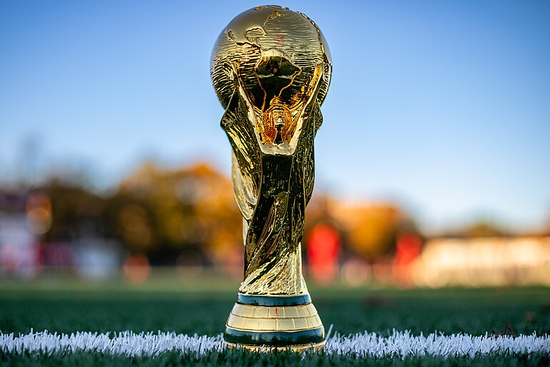 Prize for the World Cup competition with the football field on the background