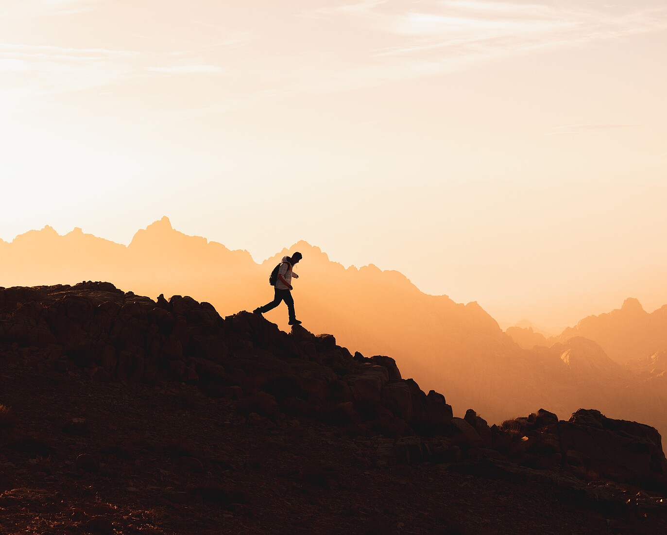 Person trekking downhill on a difficult terrain.