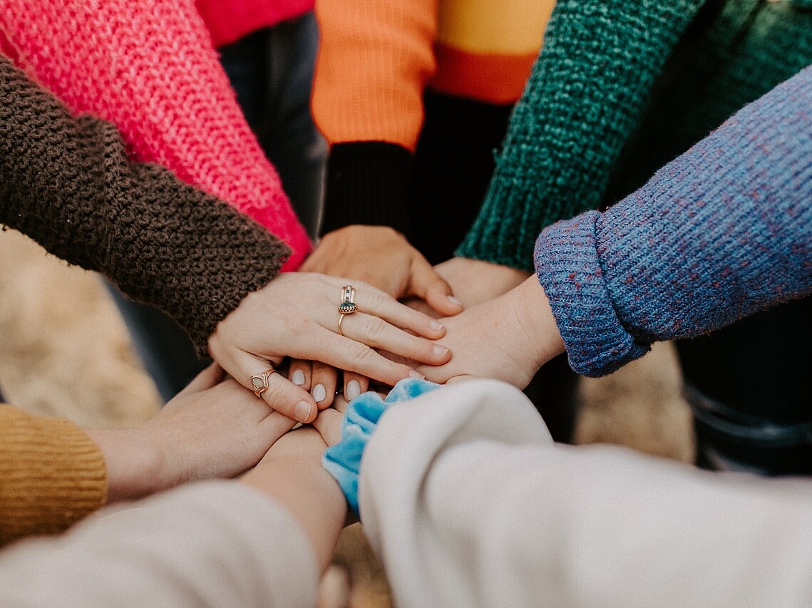 People putting their hands on each others hands