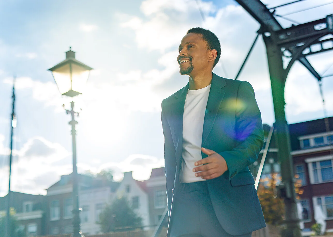 smiling man in suit with blue sky 