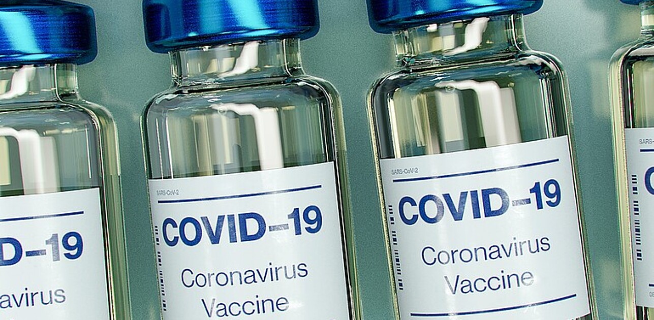 An image shows bottles with Corona Virus and Covid 19 vaccines