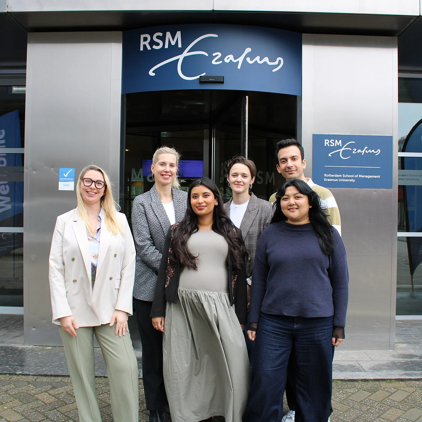 The Online Master's team standing in front of a building on the RSM campus