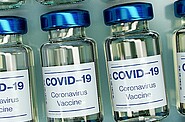 Multiple vaccination bottles are shown