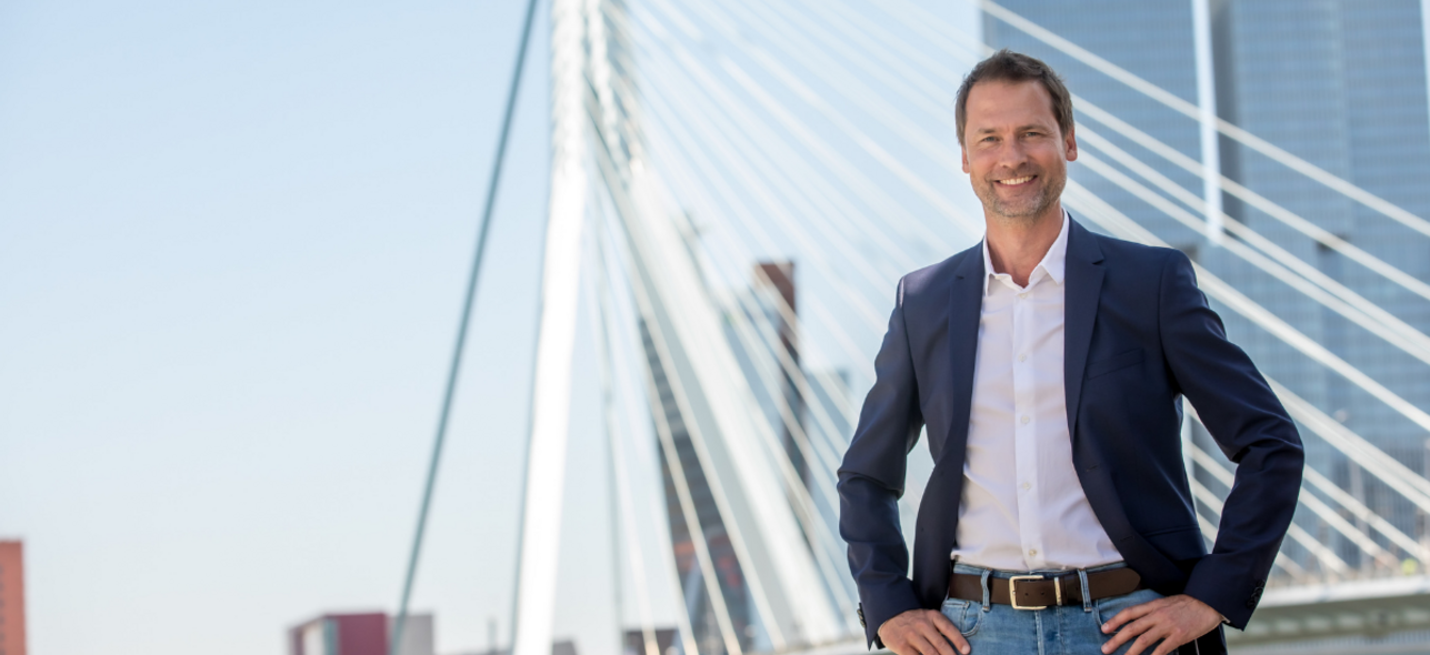 Man in front of bridge