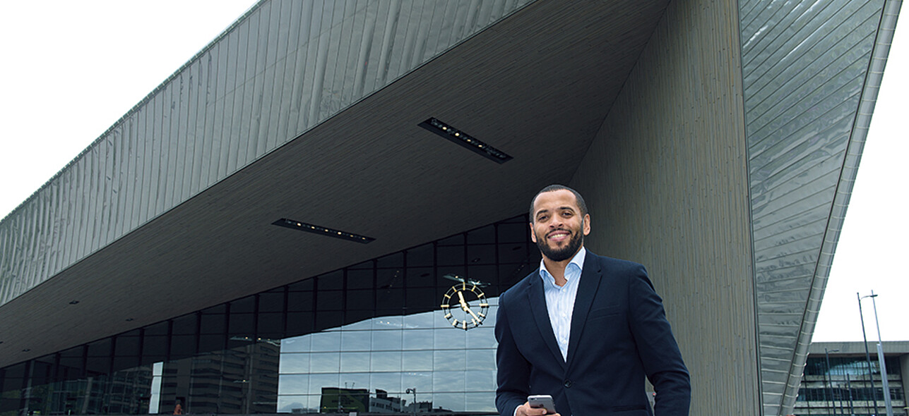 Man standing in front of Rotterdam Central Station