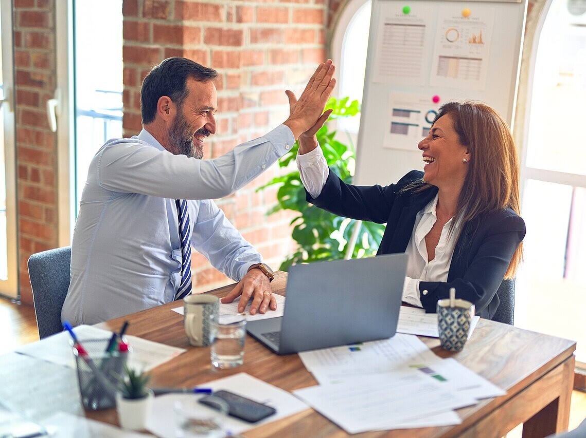 a woman and man high fiving each other