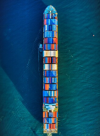 A photo shows a cargo containership in the sea or ocean