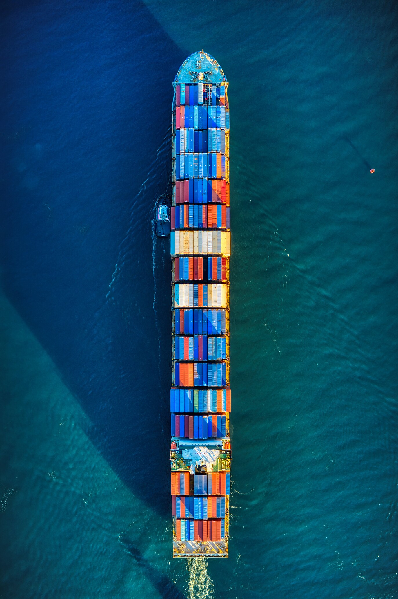 A photo shows a cargo containership in the sea or ocean