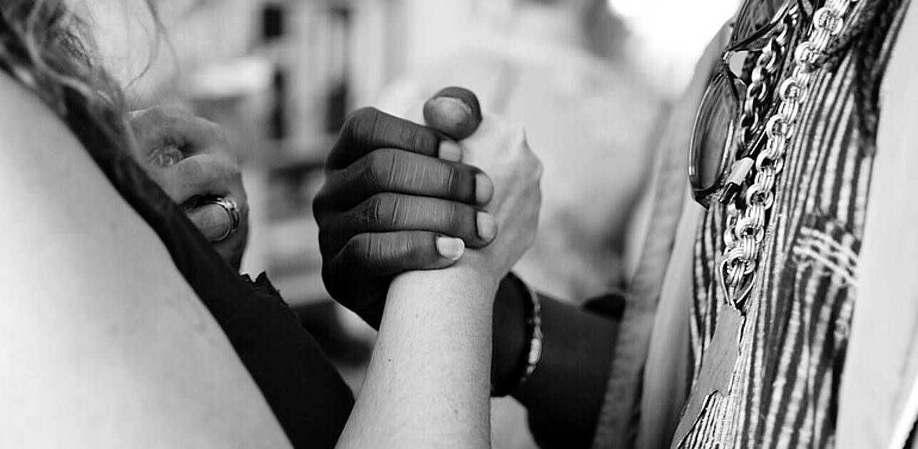 Photo shows two people shaking hands