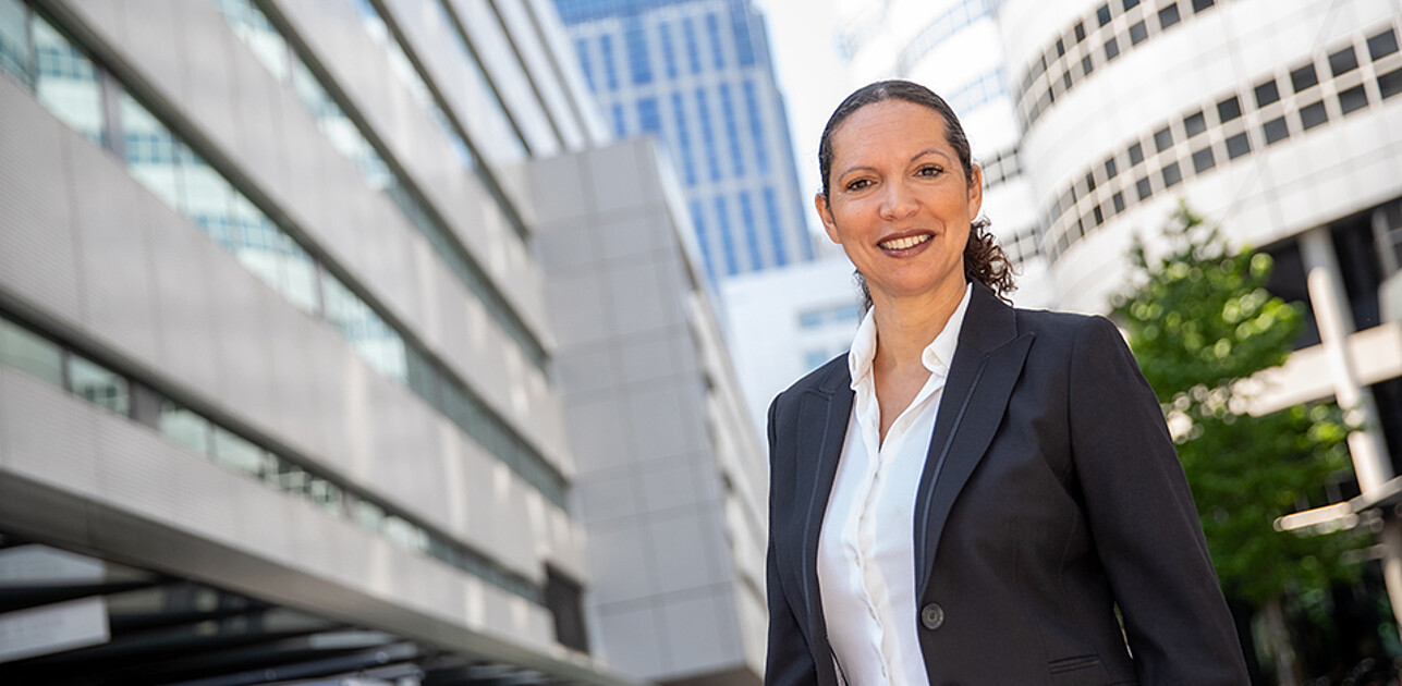 A woman in finance in front of buildings