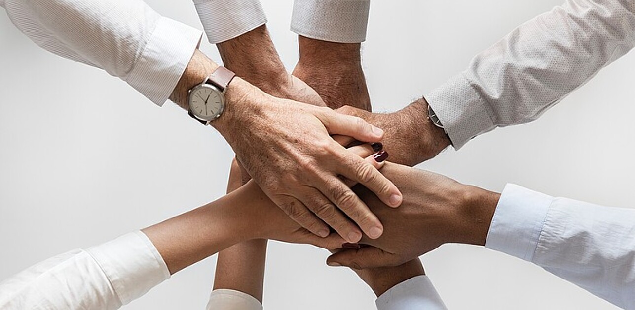 Hands touching in a circle
