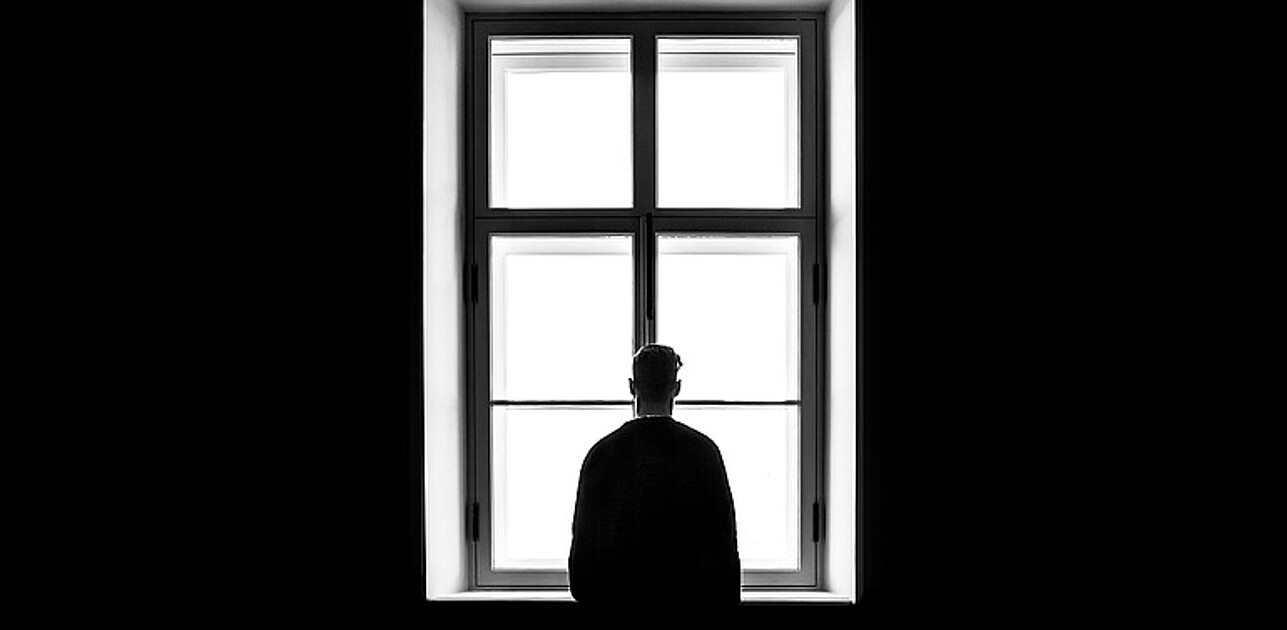 Person standing in front of window