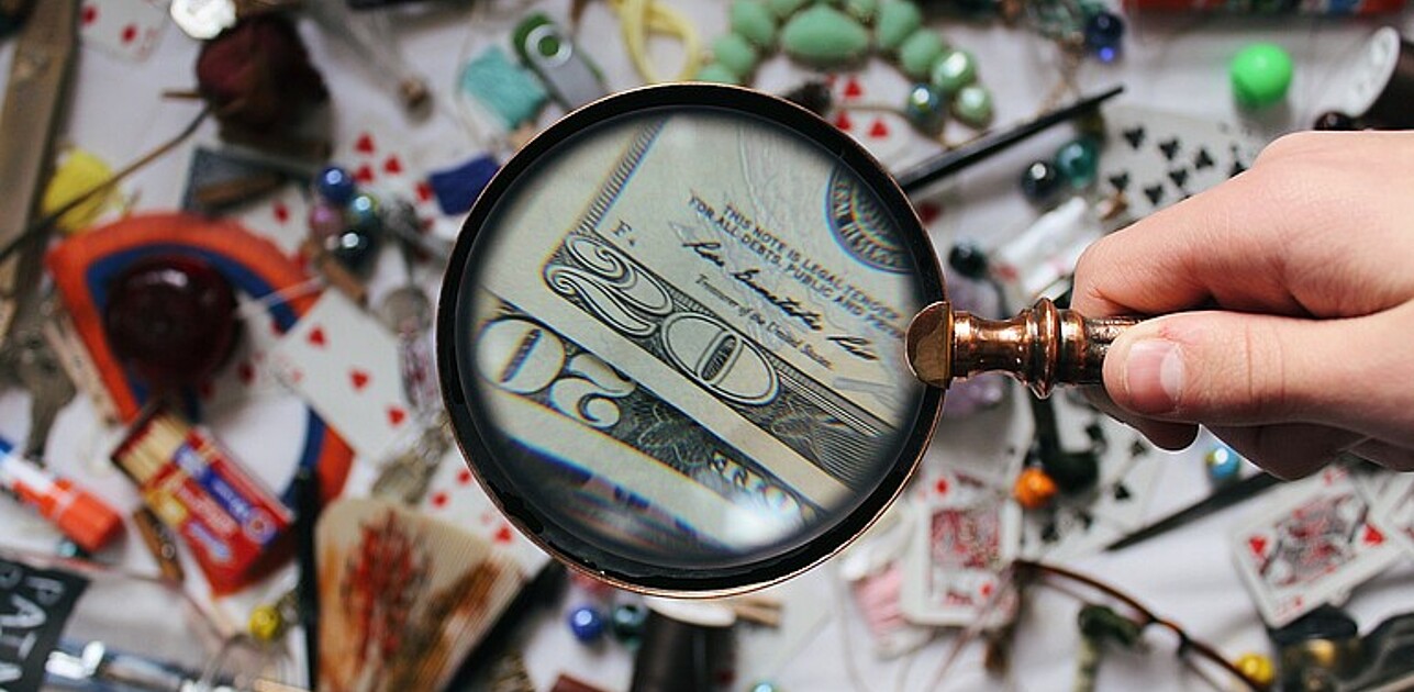 dollar bill under magnifying glass