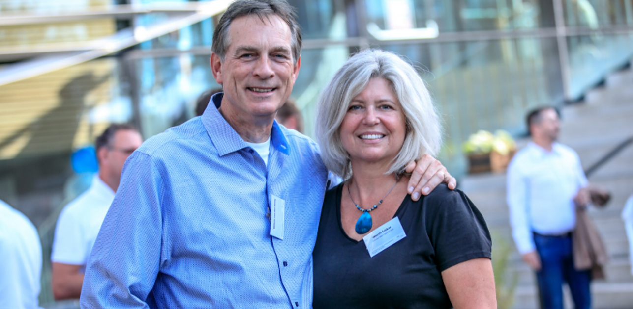 Two people standing next to each other for a photo