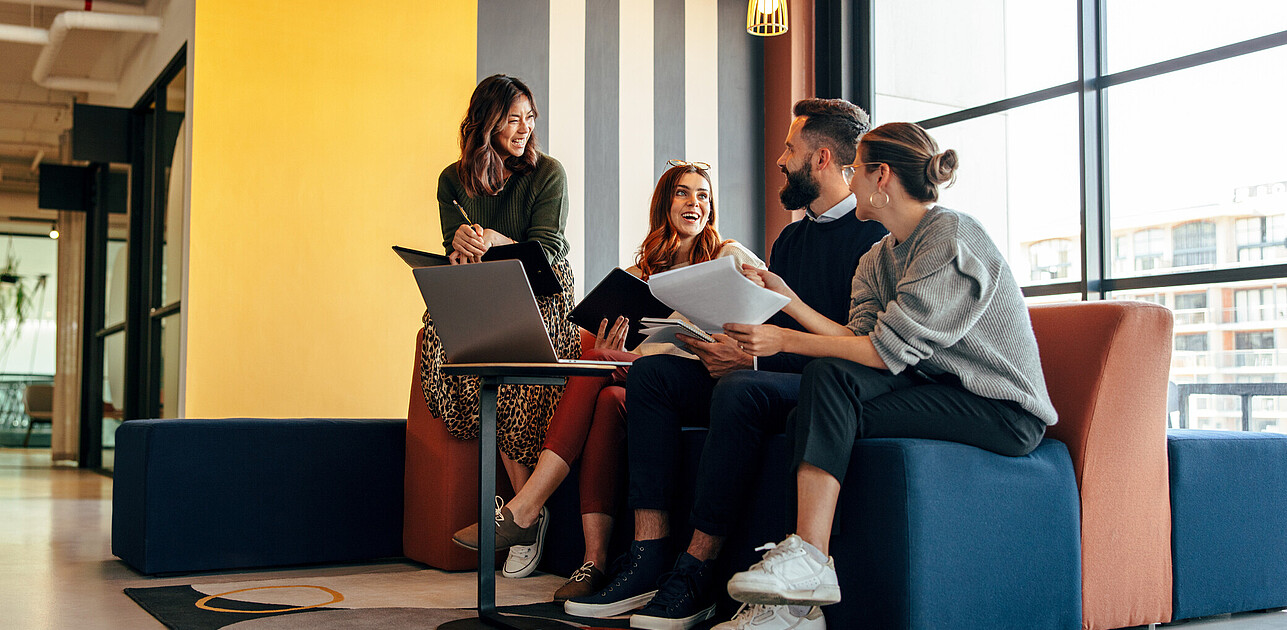 A group of people chatting with each other