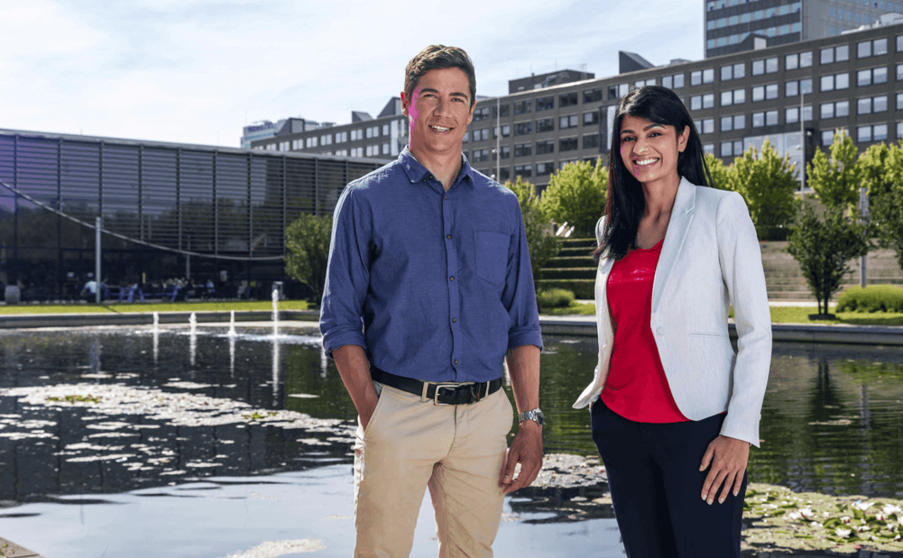 female and male students professionally posing looking at the camera on campus 