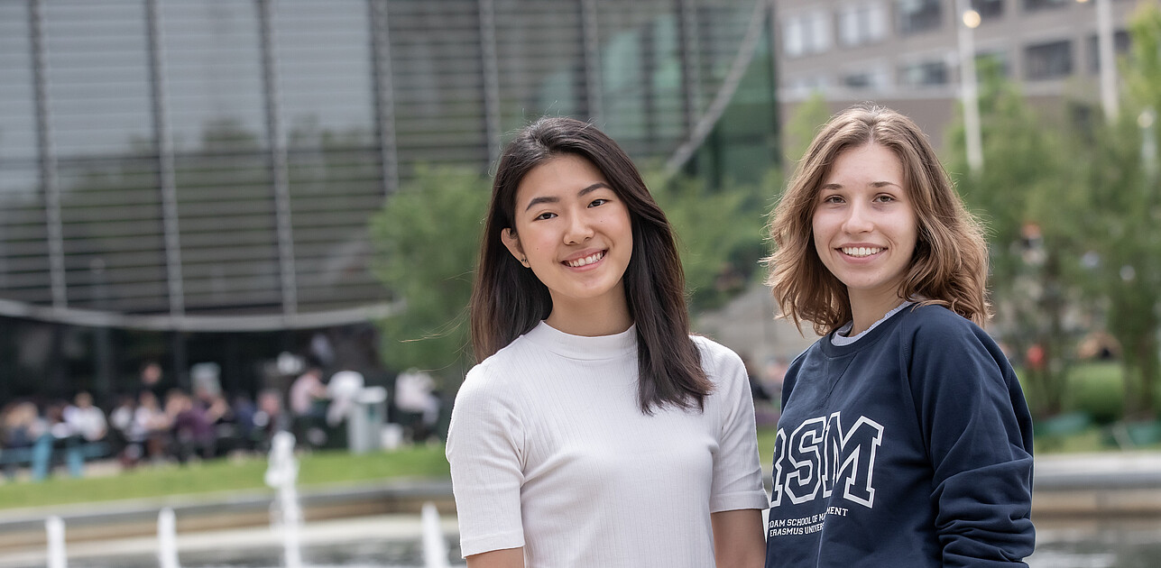 Two students from the International Business Administration programme at RSM University posing for a photo on the beautiful Erasmus University Campus.