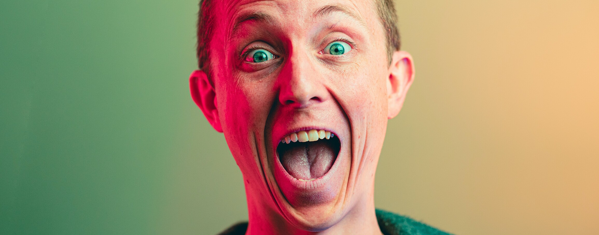 Photo shows a surprised or angry man with the yellow and green background