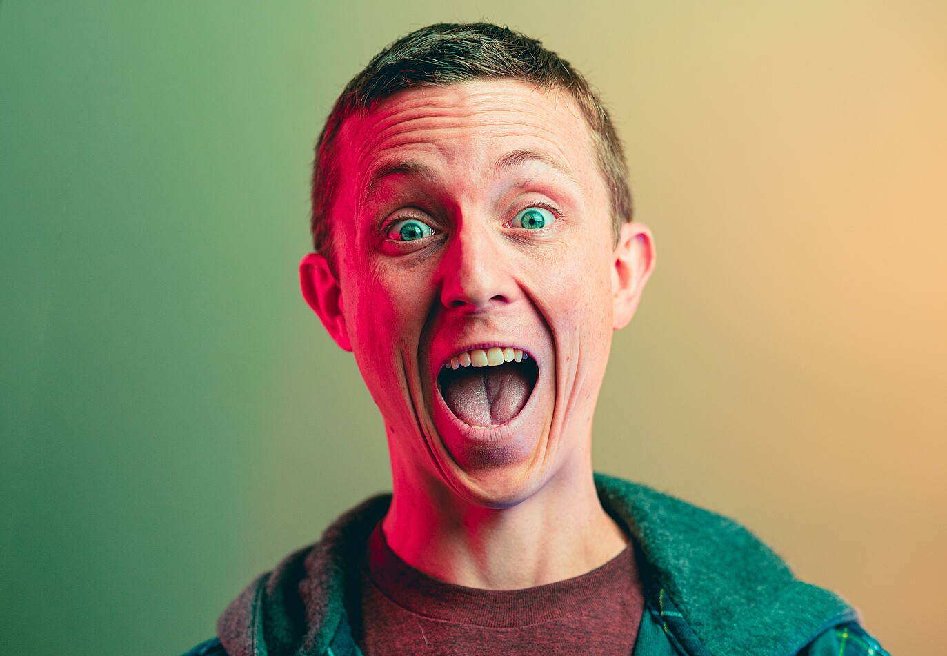 Photo shows a surprised or angry man with the yellow and green background