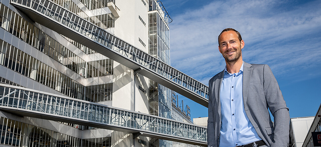 Man standing in front of modern office building