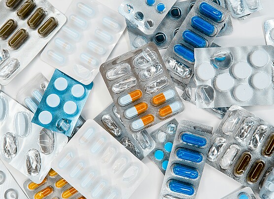 Assorted blister packs of generic medicines, many of them partly or completely empty, illustrating concerns about medicine shortages.