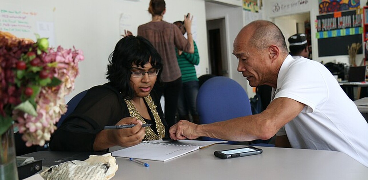 Two colleagues working together in an office.