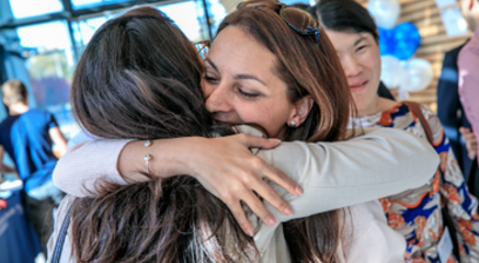 Two people hugging each other