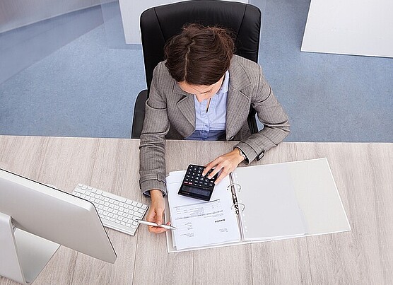 a woman working and she is calculating something