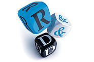 Three dice captured mid-fall, displaying the letters 'R', '&', and 'D' to spell out 'R&D'.