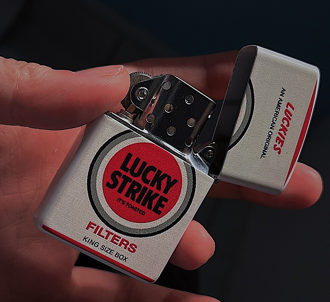 Lucky Strike branded zipper lighter with iconic logo design.