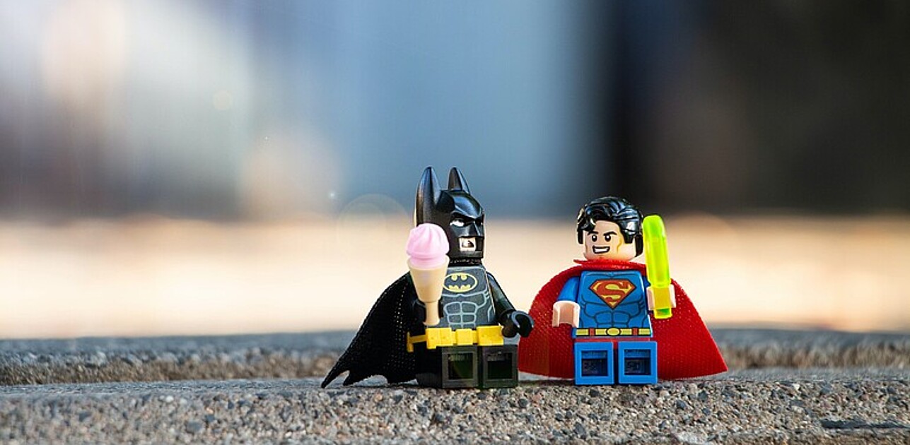 An image shows two superhero lego figures: Batman and Superman