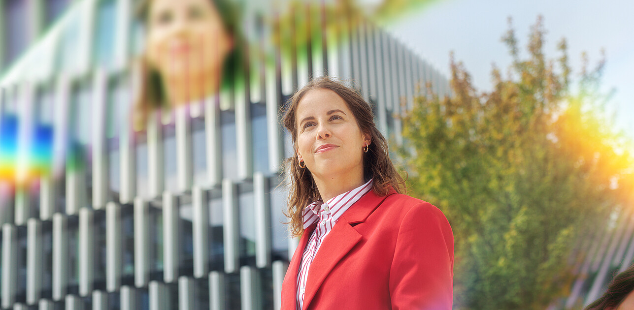 A woman standing on the Erasmus University campus with prisms around her.