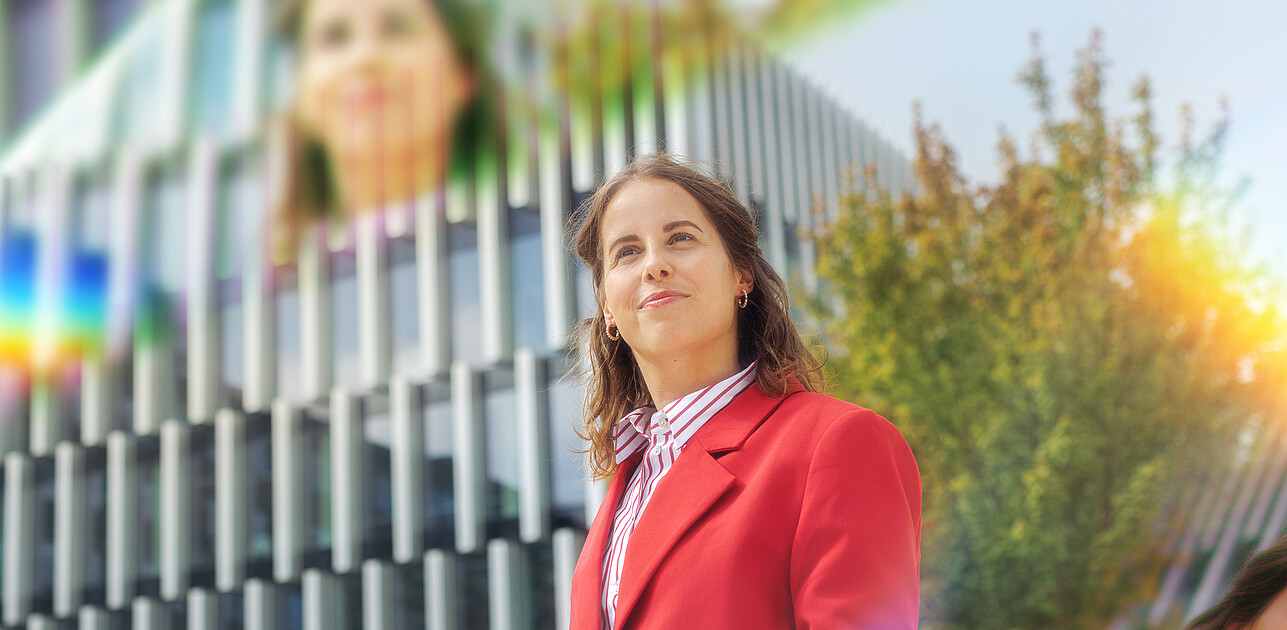 A woman standing on the Erasmus University campus with prisms around her.