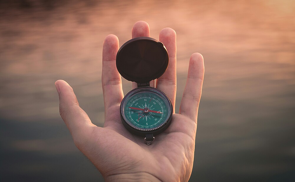 Hand holding compass