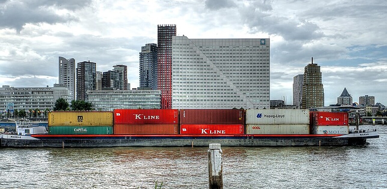 Cargo ship in front of rotterdam skyline