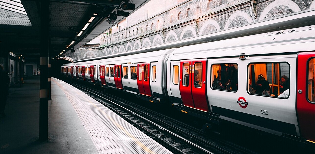 Underground train going past station