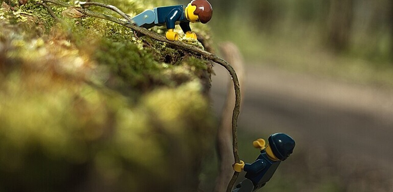 lego figures climbing a mountain