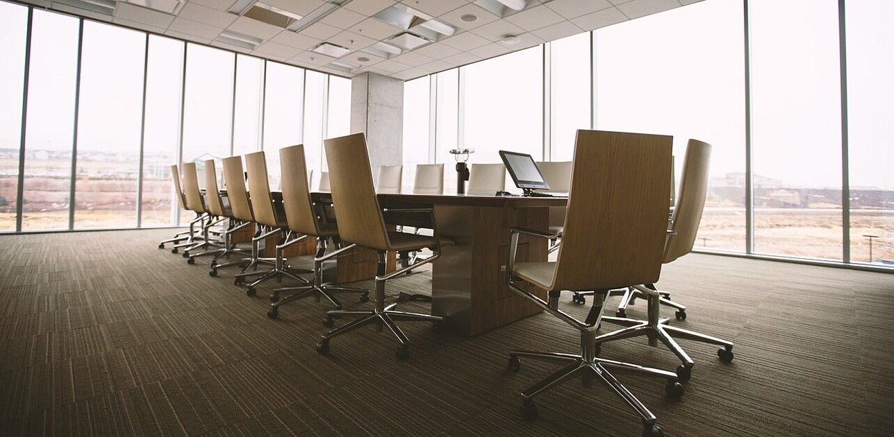 a meeting desk with empty chairs