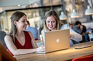 Two women in front of a computer