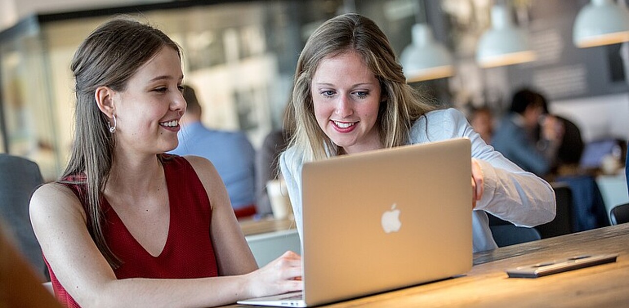 Two women in front of a computer