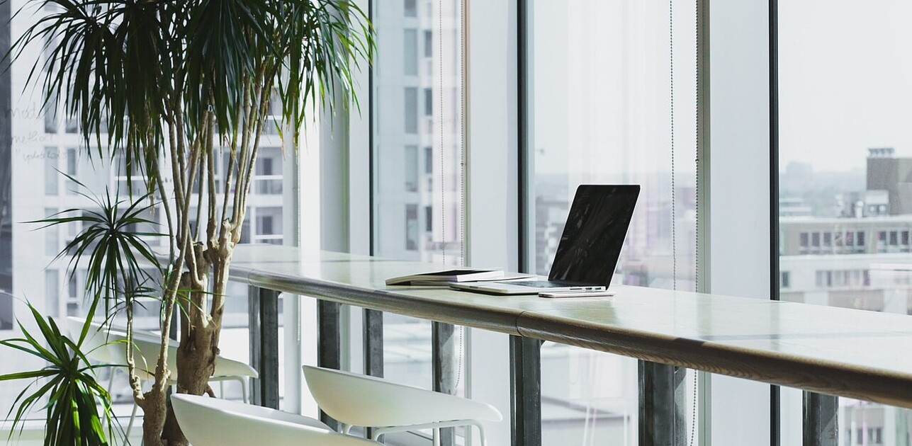 a laptop on an empty desk