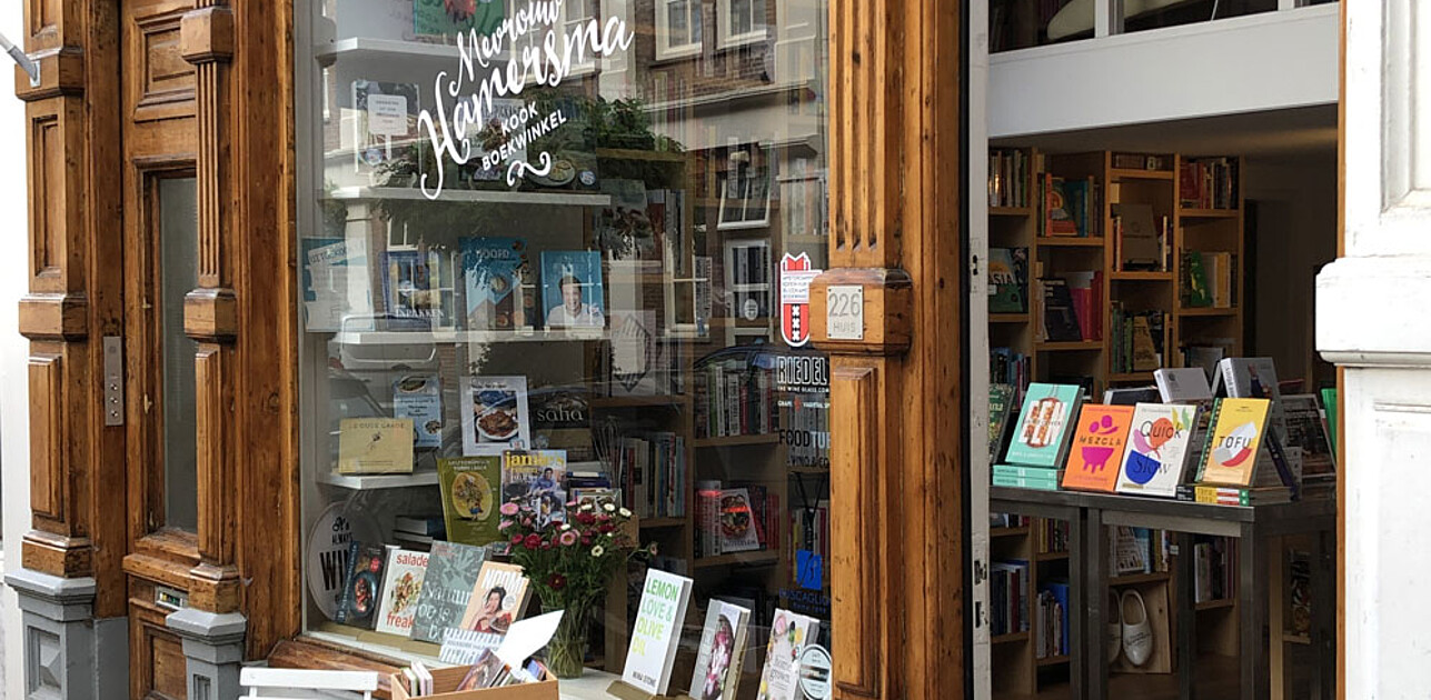 Photo shows shop window of Mw. Hamersma with books