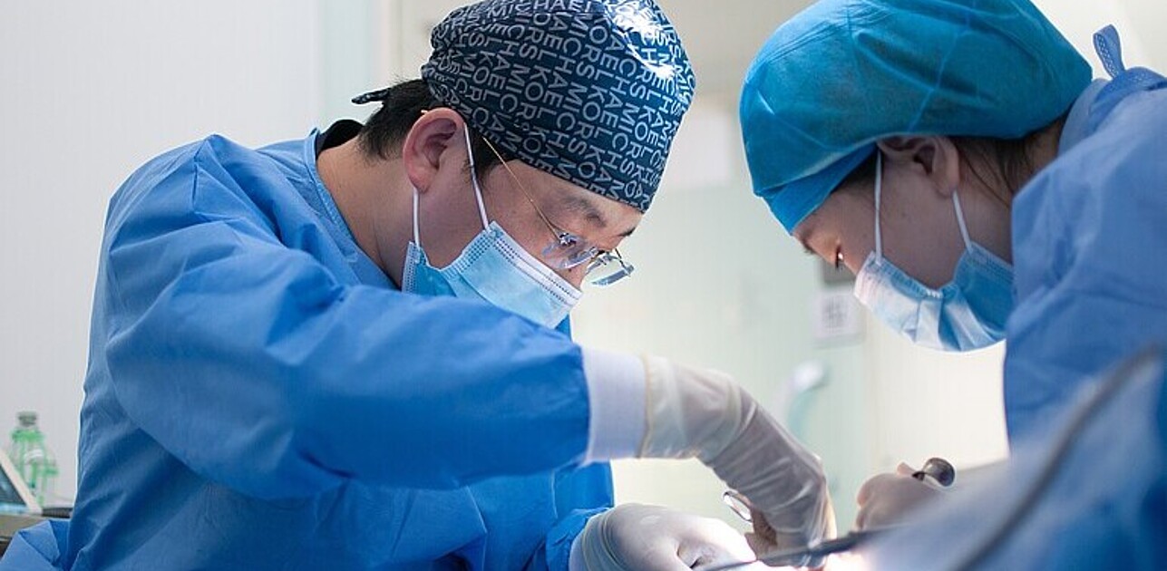 Two surgeons operating on a patient.