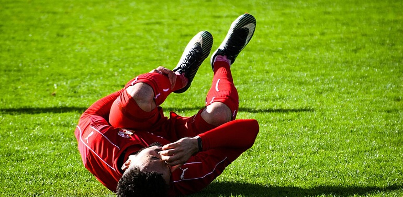 Injured football player on the ground.