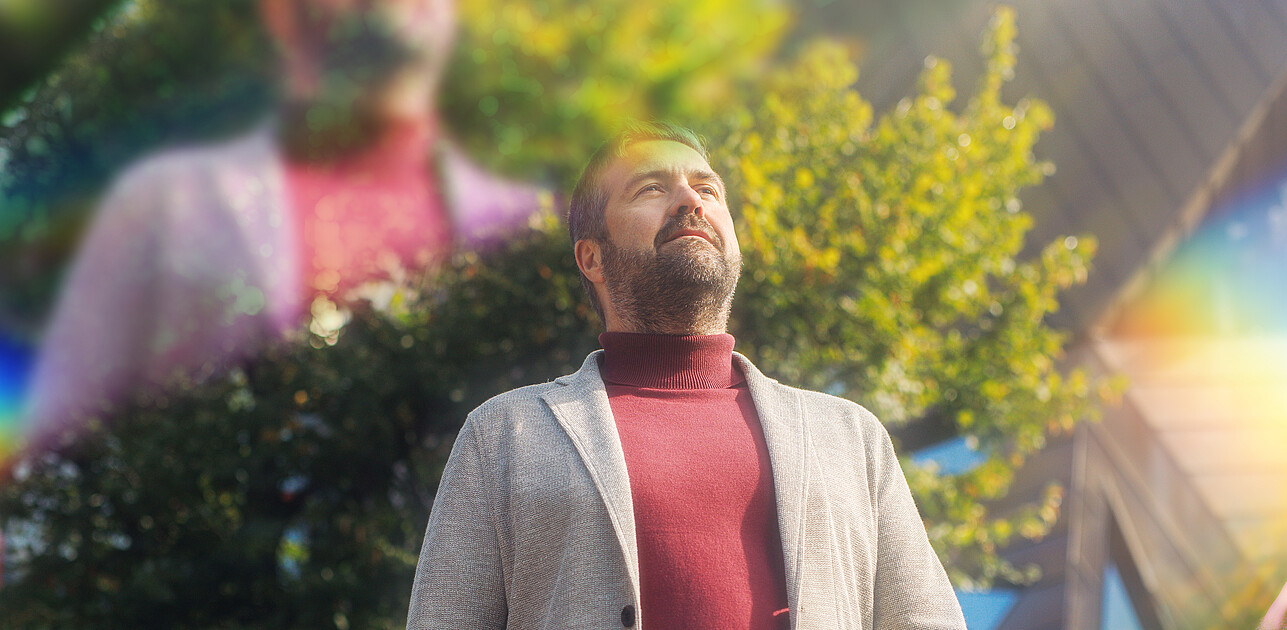 A man standing in Rotterdam with prisms around him.