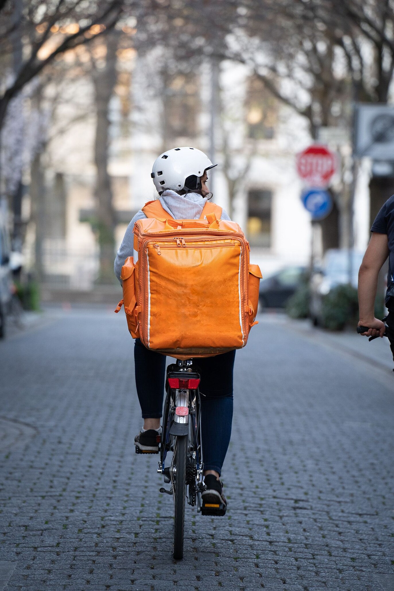 A photo of food delivery driver on the bike 