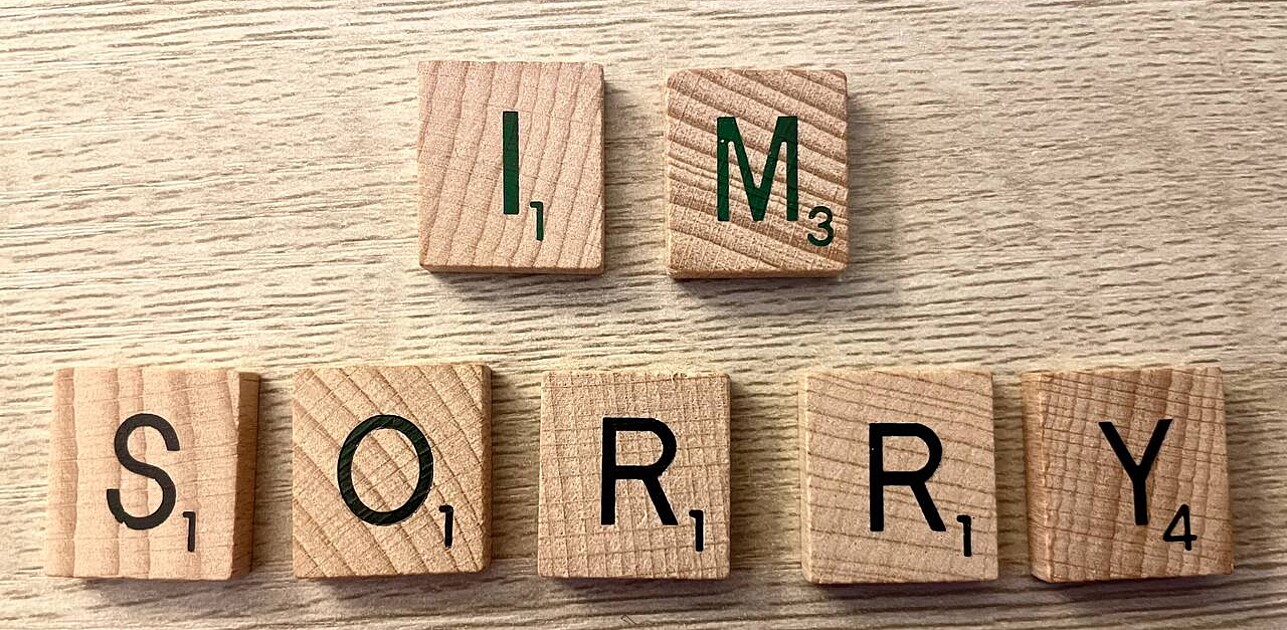 Letter cubes arranged to spell out 'I'm sorry', emphasizing an apology or expression of regret.