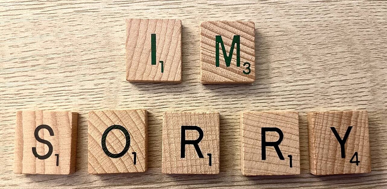 Letter cubes arranged to spell out 'I'm sorry', emphasizing an apology or expression of regret.